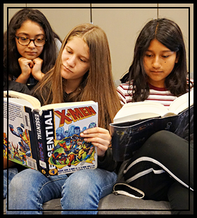 three students reading books